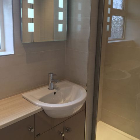 shower enclosure tiles sink illuminated mirror