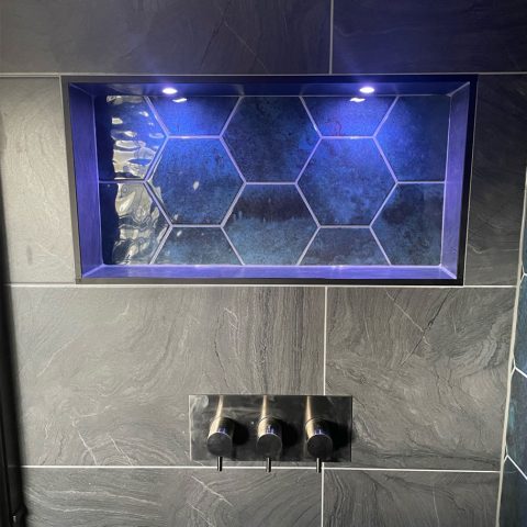 walk in shower illuminated tiled cove